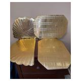 Grouping of (8) total shiny gold placemats - there are 4 of each pattern