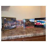 Grouping of (4) NEW nicely designed puzzles - far left & right are sealed