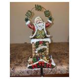 Resin Santa holding Ho Ho Ho sign stocking holder - 12” tall