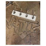 Grouping of wall hung towel rack and several over-the-door hangers