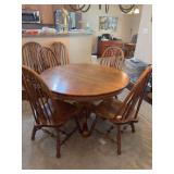 Vintage solid oak round pedestal table with (6) vintage fiddleback Windsor-style chairs - all show wear from normal use but set is very solid