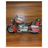 Rustic vintage-style decorative metal motorcycle model featuring a vibrant red finish and classic black saddle details