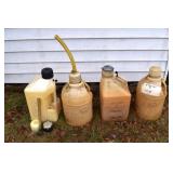 3 fuel jugs with old fuel, empty jug with extra li