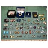 Collection of vintage costume jewelry pins and ear