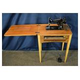 Singer model 99 sewing machine in wood cabinet, 23