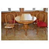 Oak finish 48" round pedestal table with leaf and