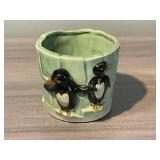 FLOWER PLANTER WITH PENGUINS ON IT