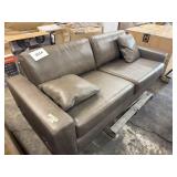 Gray leather style sofa- end damaged -holes
