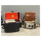Vintage Polaroid Cameras In Cases