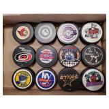(12) Assorted Team Hockey Pucks