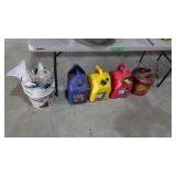 Gas cans and bucket slot tile spacers under table