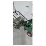 Pair of Scots lawn fertilizers and hose