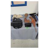 Lot of holsters and pistol cases as shown