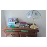 costume jewelry and lamp on top of dresser