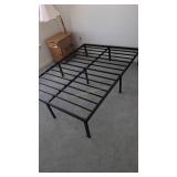 metal double bed frame with picture on wall