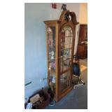 oak lighted curio cabinet with mirrored back