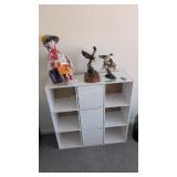bookcase with figures on top