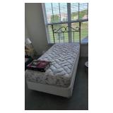 single bed with bedding brass headboard