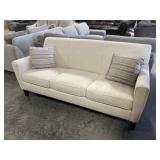 Whiteish Upholstered Sofa with Pillows