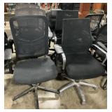6 Black Office Arm Chairs On Wheels.
