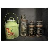 3 metal lanterns and a metal jug.   Tallest
