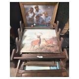 Lot of various pictures and a gun rack.   Tallest