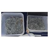 Two plastic containers of fence staples