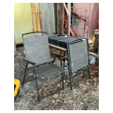 Table with wood top and 4 folding lawn chairs.