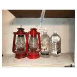 Pair of lanterns and 1 1/4 jugs of lamp oil