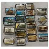 Assortment of historic buildings and destination glass paperweights