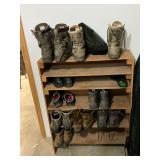 Large assortment of hunting footwear and wooden shelf