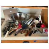 Large stainless mixing bowl with kitchen utensils