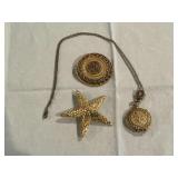 Gold toned starfish pin, round gold tone brooch