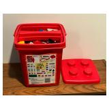 Red Lego bucket with assorted Legos
