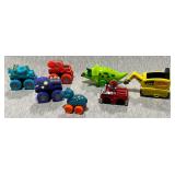 Plastic Paw Patrol and dinosaur cars.