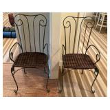 Pair of metal framed chairs with woven bottoms