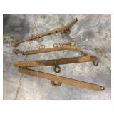 2 metal horse hames and 2 metal draw bars