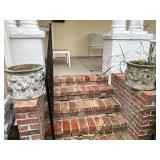 Pair of concrete plants with cracks