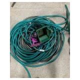 Two large garden hoses, sprinkler and spreader