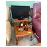 Hard rock maple step end table along with a JVC Model LT22E710 television, small shelf clock, brass duck ashtray and coasters