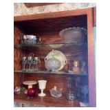 Various glassware includes 3 footed candy dish, small punch bowl, chrome edge wine glasses, hand painted bowl, ruby red dish, Christmas pattern wine glasses, Fostoria candlesticks and more