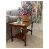 Oak spindle leg table with lower shelf and decor Measures 16 x 22 x 18in tall