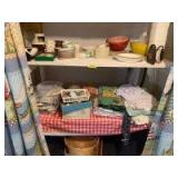 Everyday dishes, plastic ware, electric knife, air corn popper, sewing notions, disposable dinnerware and flatware, two baskets variety of doilies and table linens