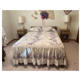 Double bed with bedding and matching curtains, pair of nightstands and table lamps