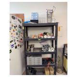 Shelf contents includes stainless steel cans, outlet adapters, suction cup bath accessories, baskets and more