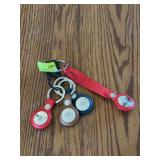 Five Apple air tags with covers, fifth one found at later time