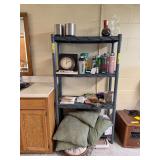 Contents on shelf includes pillows, drink bottles, vases, stainless steel cans, decor items