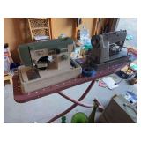 Vintage ironing board and two sewing machines, singer and riccar