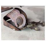 Antique spurs with tooled straps