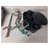 Cast-iron muffin pan, meat grinder, large steel, and apple corer slicer (cast iron lid removed)